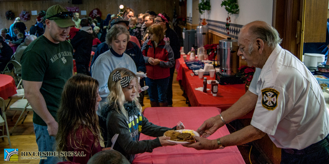 George Symington, past chief and longtime member of Beachwood Volunteer Fire Company, served breakfast for the large crowds of residents at the annual Santa breakfast at the borough firehouse.